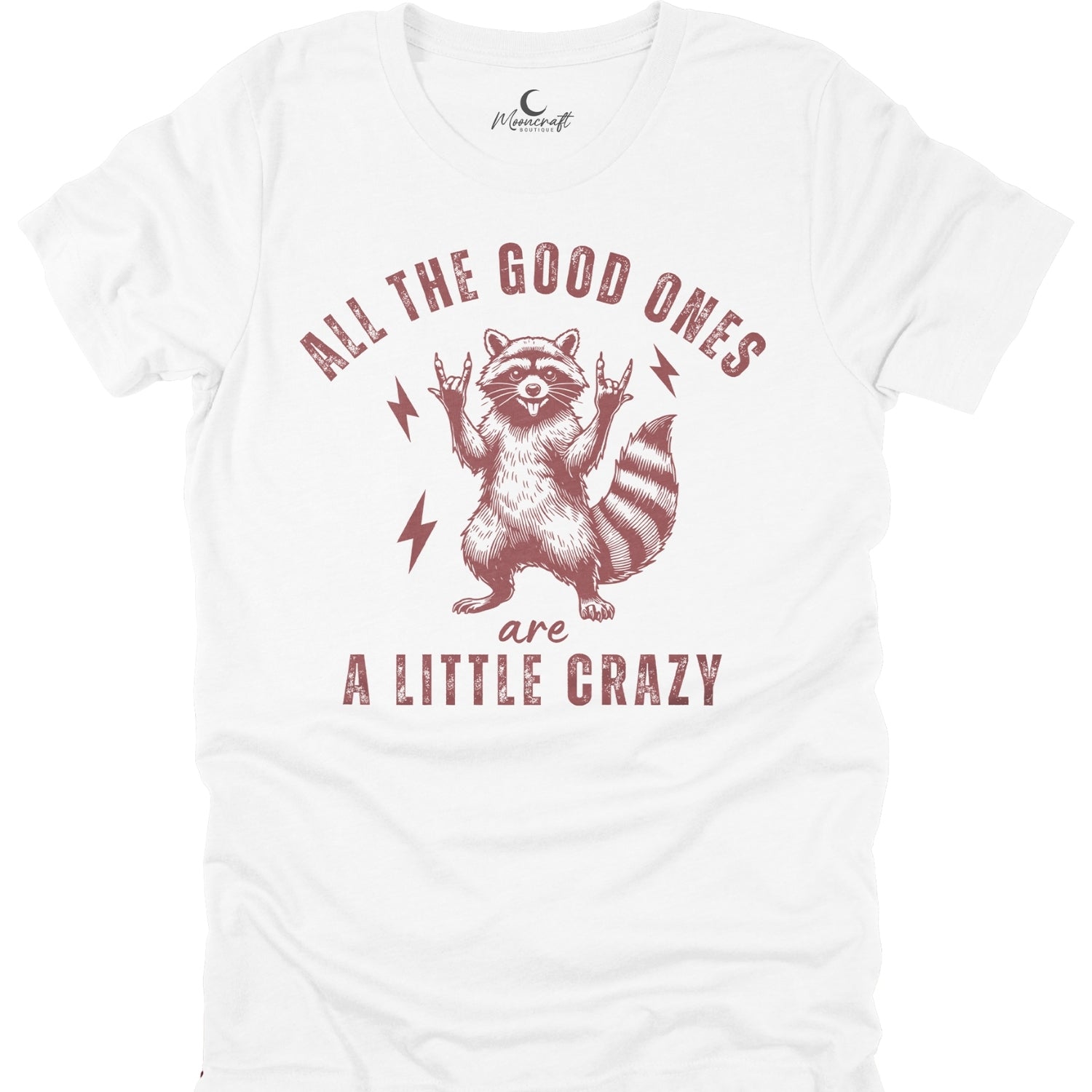 White t-shirt with a raccoon graphic and the text All the good ones are a little crazy