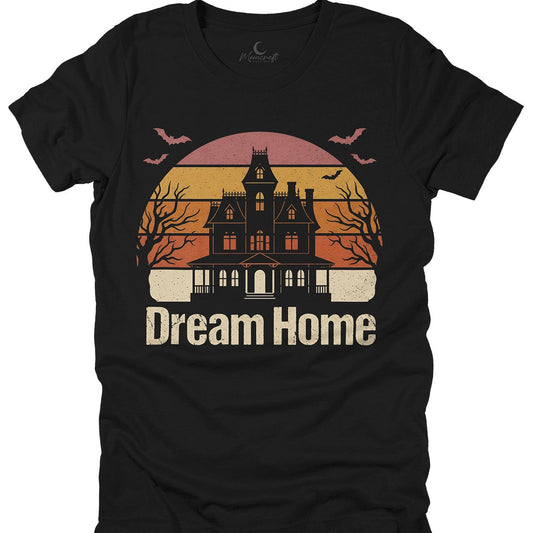 Black t-shirt with a haunted house on a retro sunset graphic and 'Dream Home' text on a white background