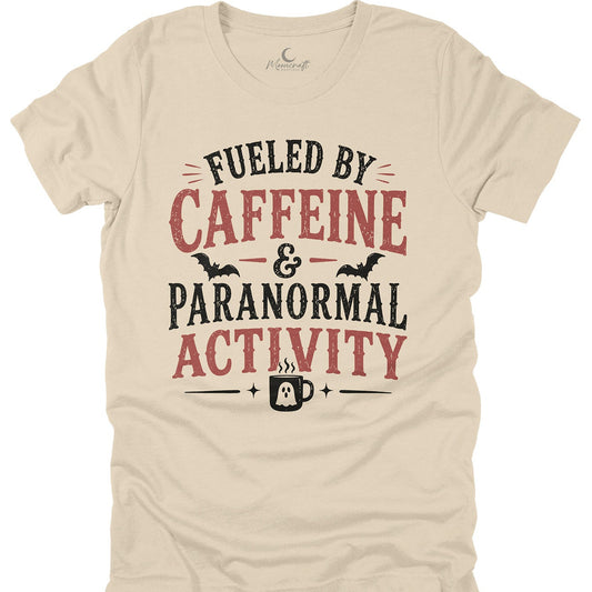 Beige t-shirt with 'Fueled by Caffeine & Paranormal Activity' text design on a white background