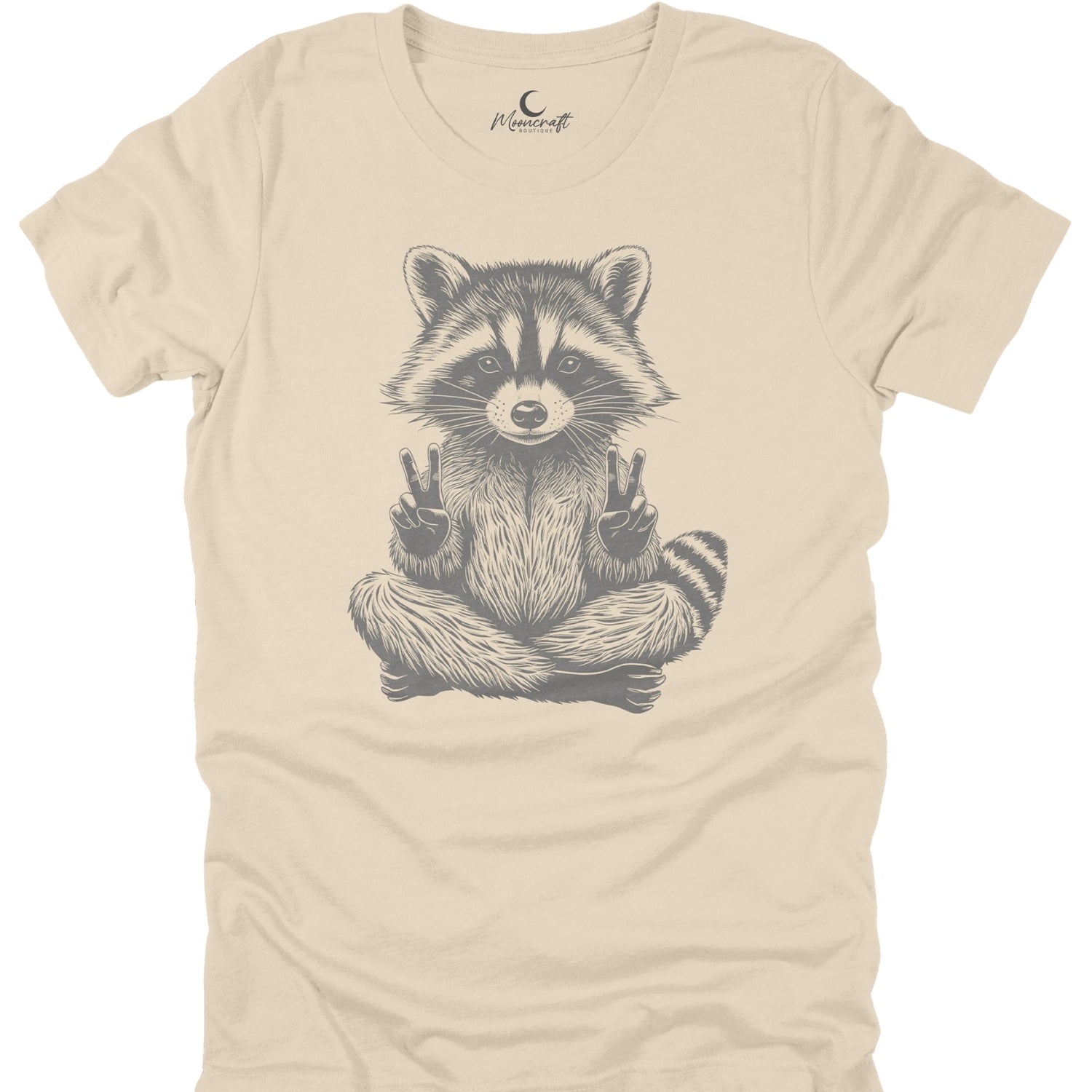Beige t-shirt with a raccoon graphic on a white background