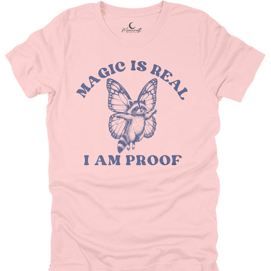 Pink t-shirt with a butterfly graphic and text 'Magic is Real, I am Proof' on a white background.