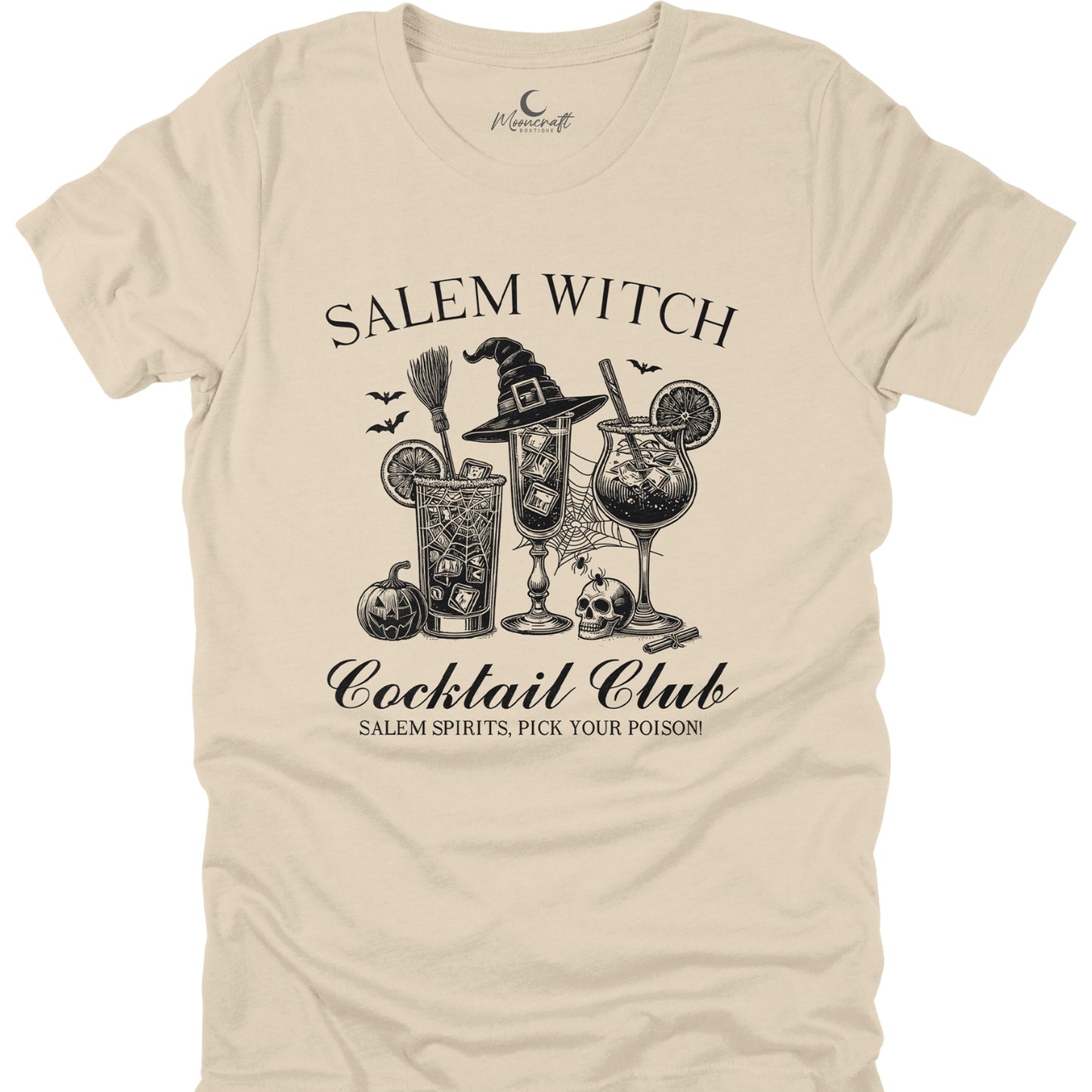 Beige t-shirt with black graphic design of a witch, broomstick, and cocktails on a white background