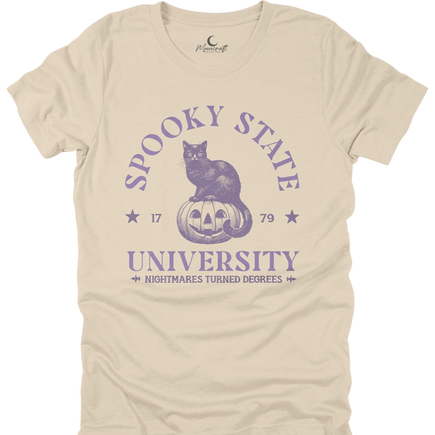 Beige t-shirt with purple graphic of a cat on a pumpkin and text 'Spooky State University' on a white background.
