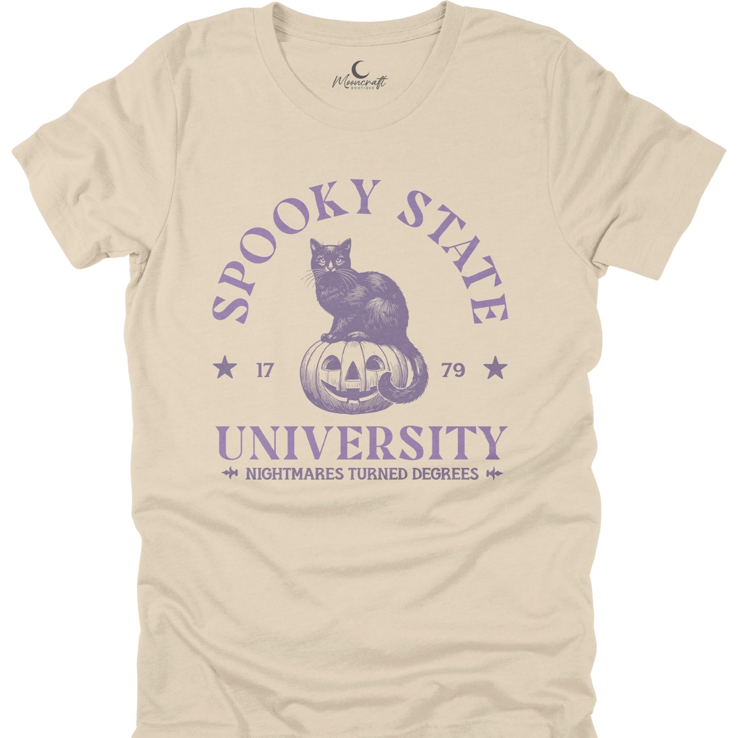 Beige t-shirt with purple graphic of a cat on a pumpkin and text 'Spooky State University' on a white background.
