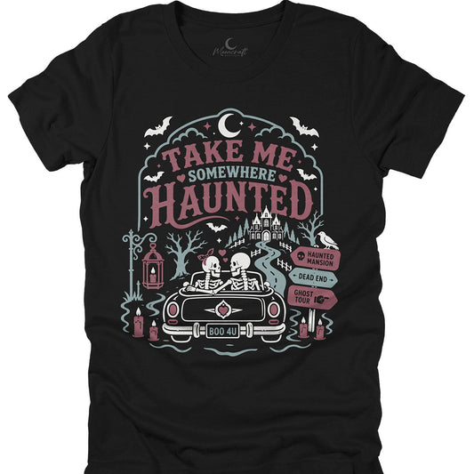 Black t-shirt with 'Take Me Somewhere Haunted' graphic design featuring a car, skeletons, and haunted castle.