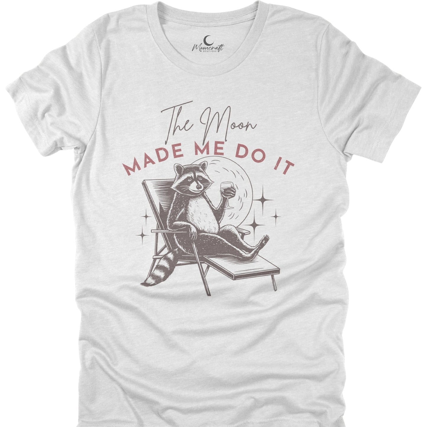 White t-shirt with a raccoon graphic and text 'The Moon Made Me Do It' on a white background
