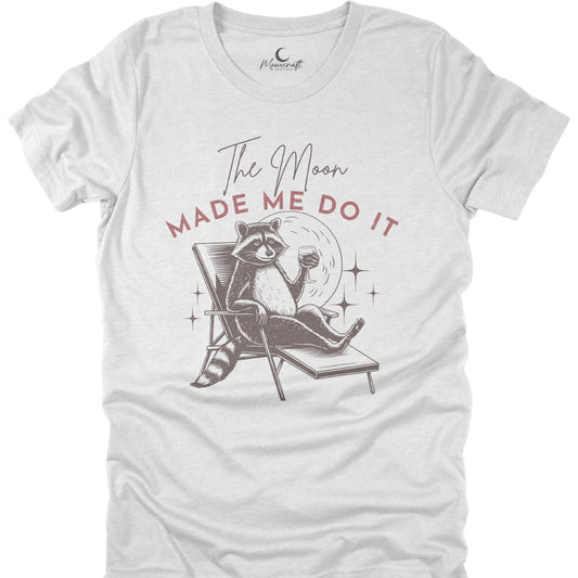White t-shirt with a raccoon graphic and text 'The Moon Made Me Do It' on a white background